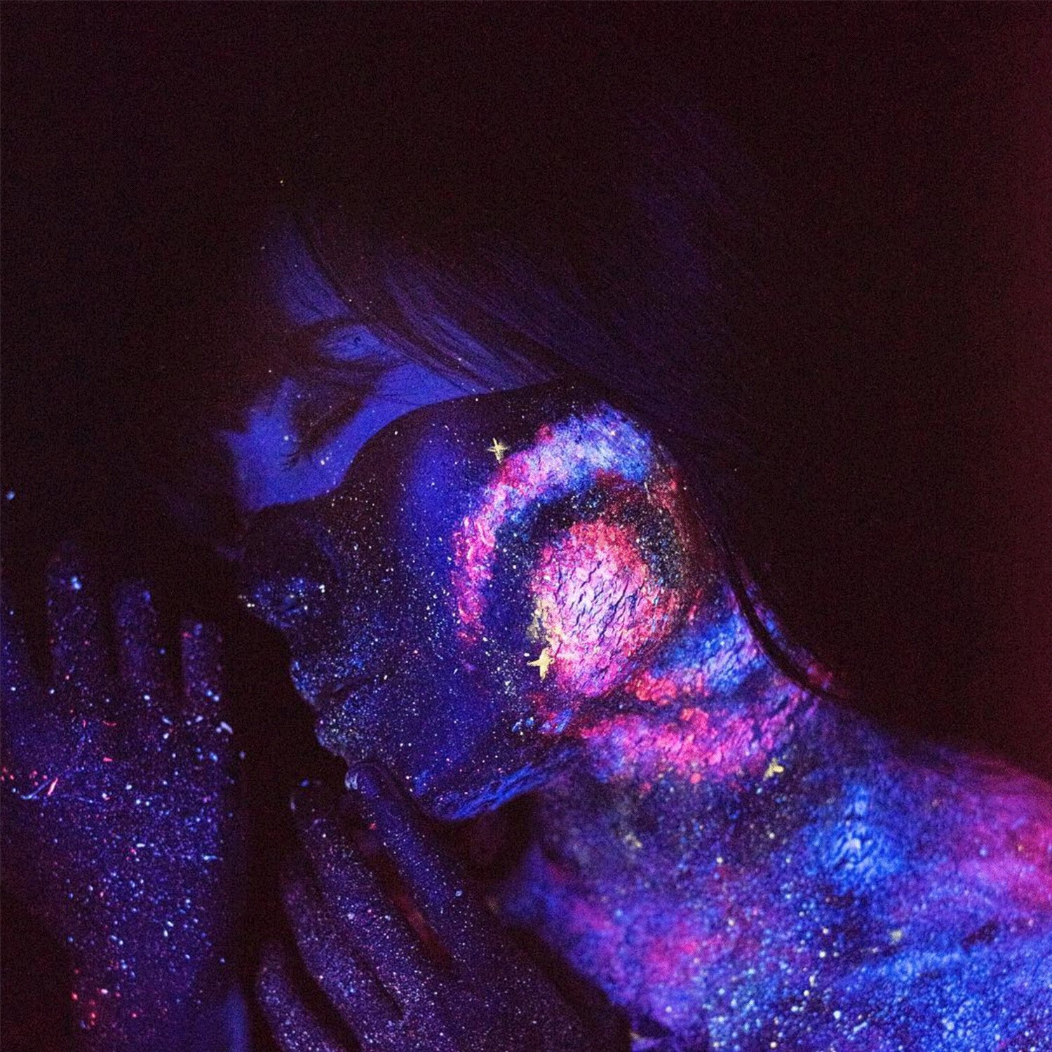Wisdom Within You — a face and hands painted with a glowing violet and pink galaxy
