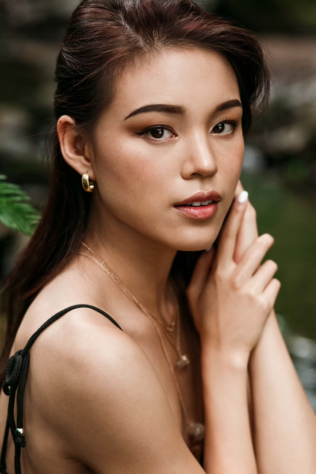 Close-up beauty portrait with glowing skin and gold earrings