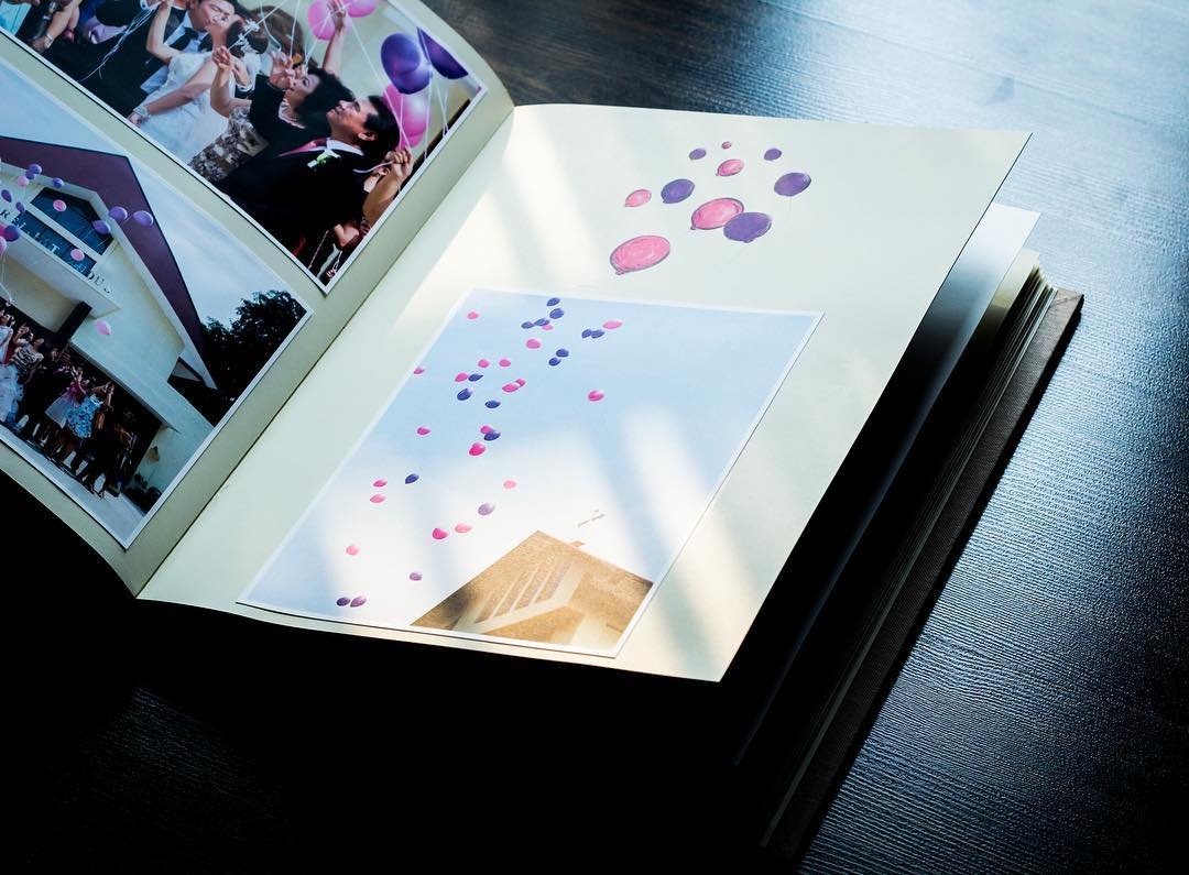 Photobook page with a pull-out insert decorated with watercolour balloons