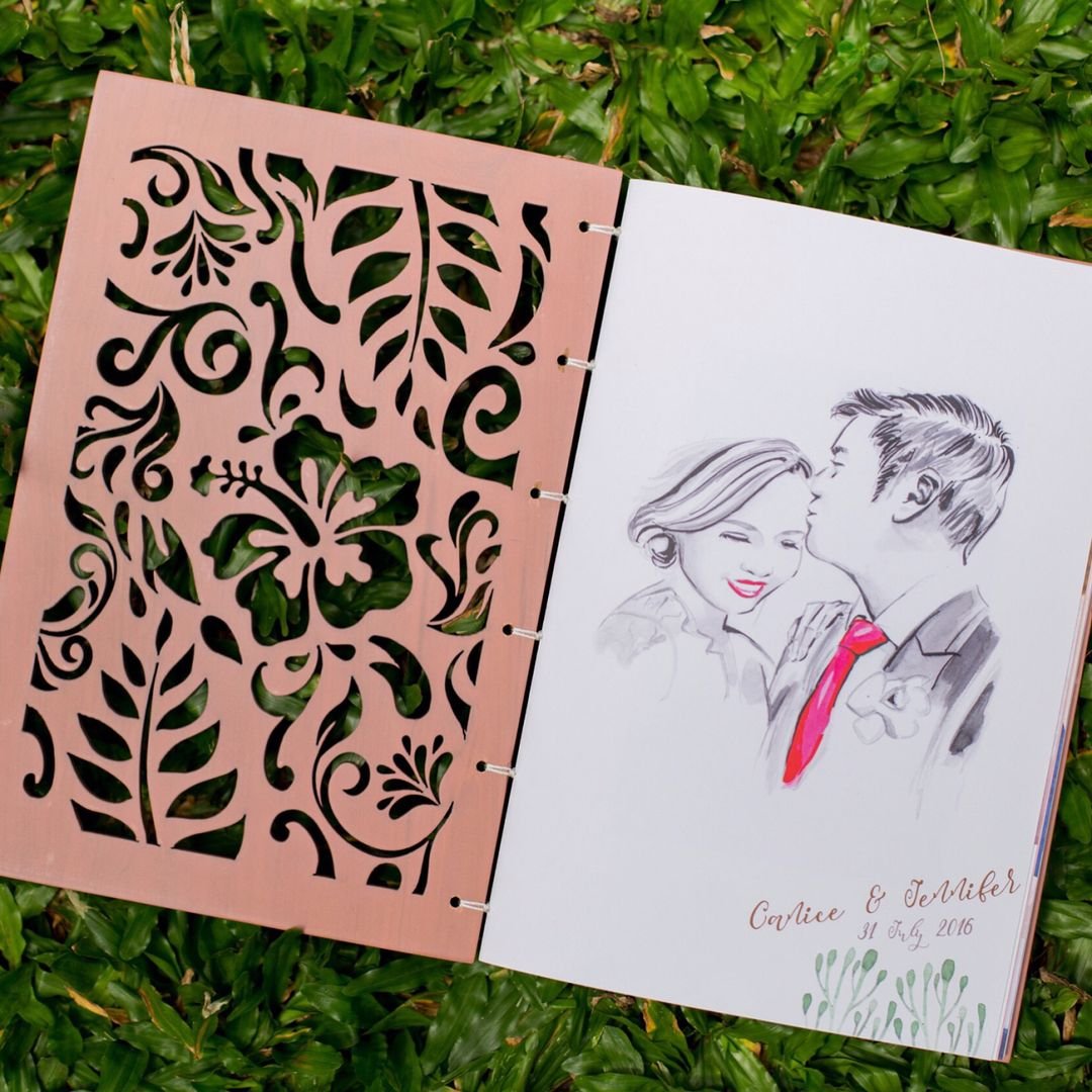 Laser-cut wooden album cover opened to an illustrated couple portrait